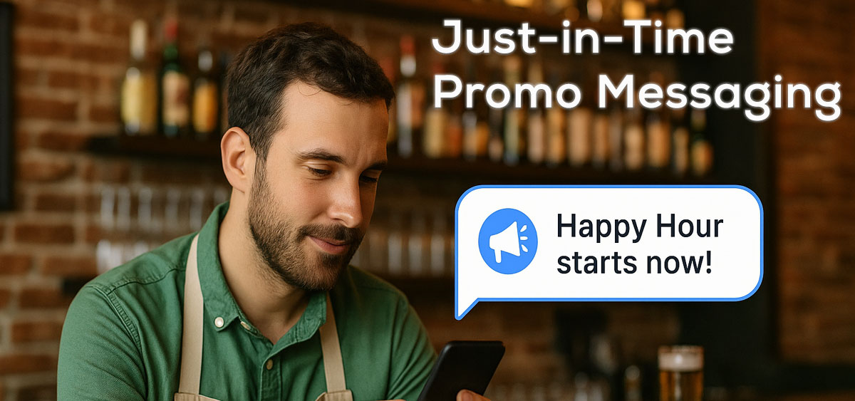 A close-up of a smartphone in a restaurant setting, displaying a 'Happy Hour starts now!' SMS notification.